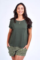 Woman wearing green print short and green top.