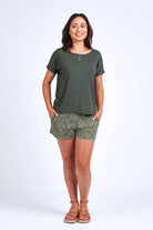 Woman wearing green print short and green top.