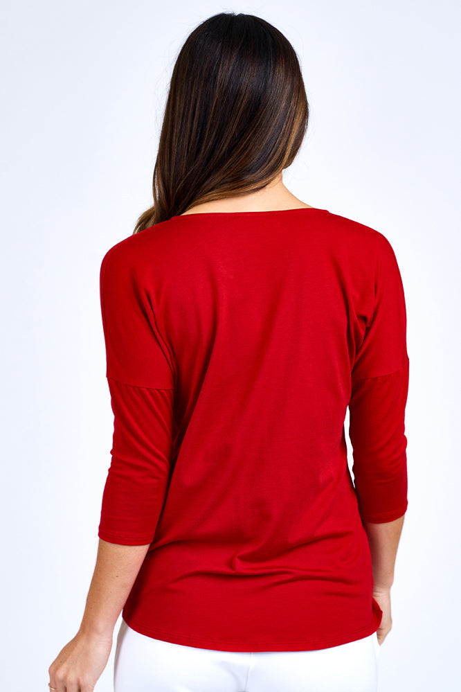  Woman wearing grey and red 3/4 sleeve top.