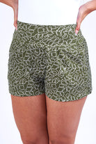 Woman wearing green print short. 