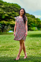 Woman wearing pink print dress.